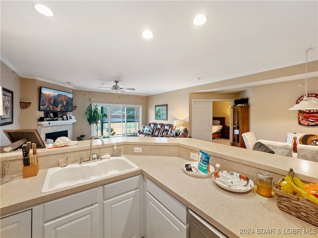 kitchen featuring sink, white cabinetry, and ceiling fan