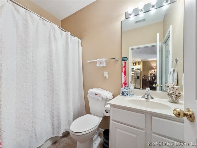 bathroom featuring vanity, curtained shower, and toilet