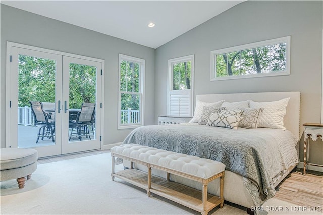 bedroom with vaulted ceiling, access to exterior, light hardwood / wood-style floors, and french doors