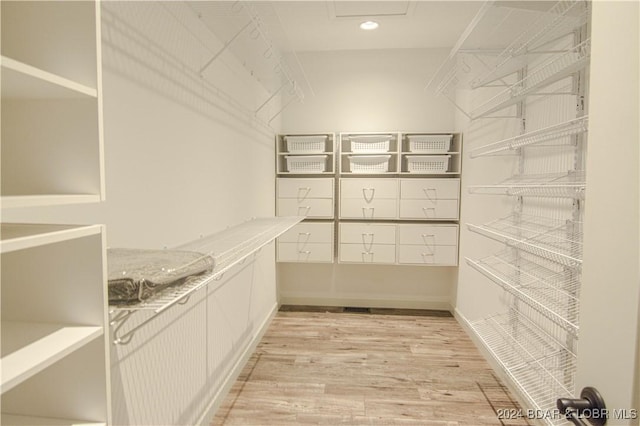 walk in closet featuring light hardwood / wood-style flooring