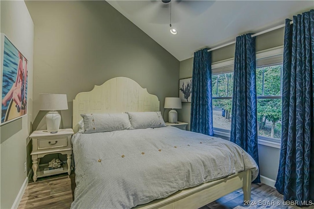 bedroom with lofted ceiling, hardwood / wood-style floors, and ceiling fan