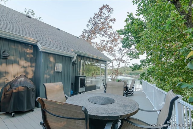 wooden terrace featuring a grill