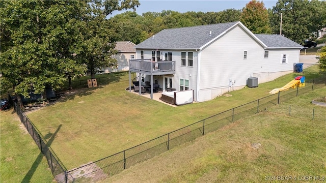 rear view of property with a lawn, a deck, a patio, and central AC