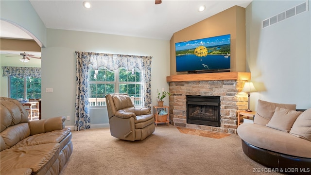 living room featuring a fireplace, lofted ceiling, ceiling fan, and light carpet