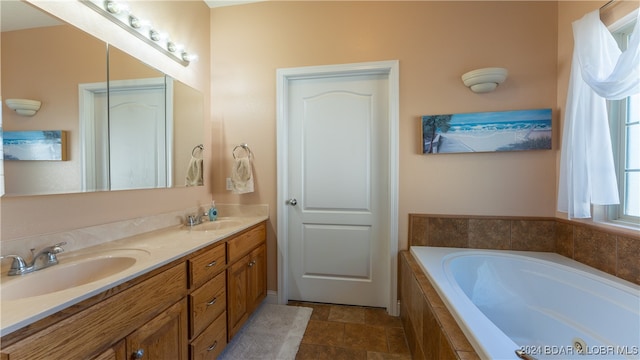 bathroom with vanity, tile patterned floors, and a relaxing tiled tub