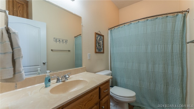 bathroom with vanity, toilet, and a shower with curtain