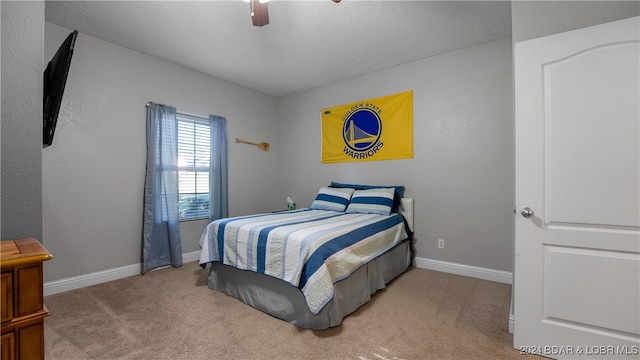 carpeted bedroom with ceiling fan