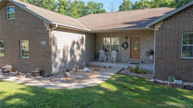 exterior space featuring covered porch and a lawn