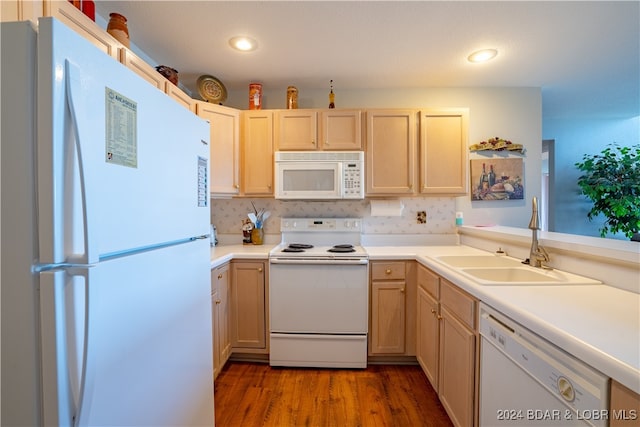 kitchen featuring dark wood-type flooring, white appliances, light brown cabinetry, and sink