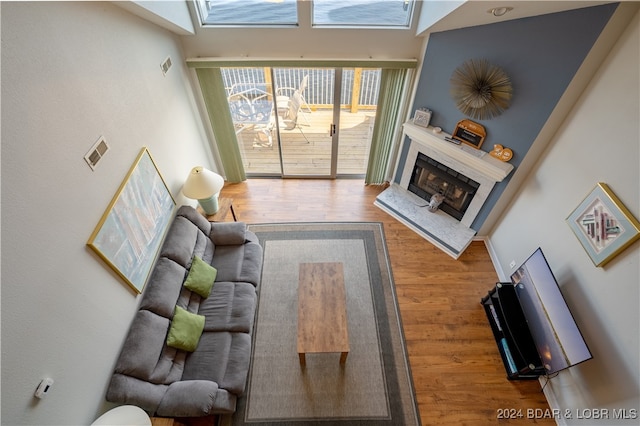 living room featuring a high end fireplace and hardwood / wood-style floors