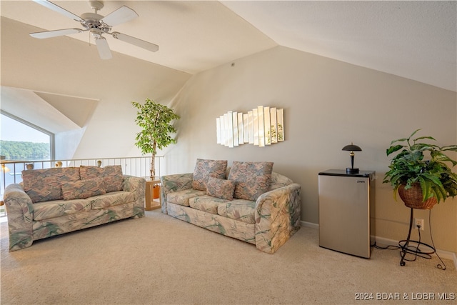 living room featuring vaulted ceiling, light colored carpet, and ceiling fan