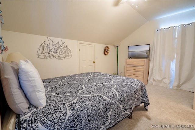 carpeted bedroom with lofted ceiling