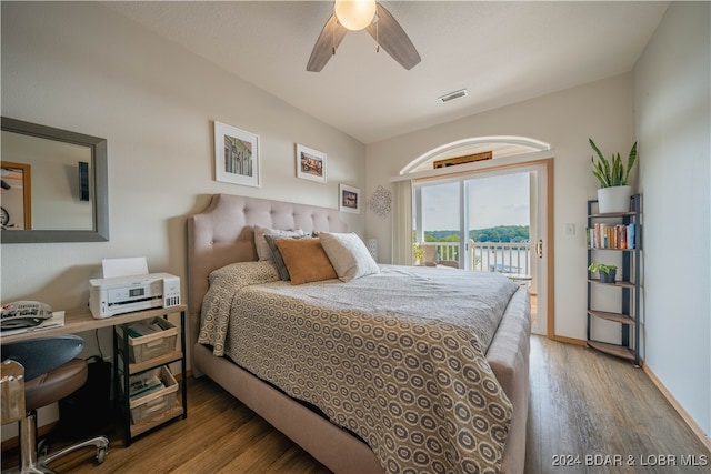 bedroom featuring hardwood / wood-style floors, ceiling fan, and access to outside