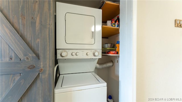 clothes washing area featuring stacked washing maching and dryer