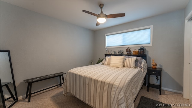 bedroom with ceiling fan and light carpet