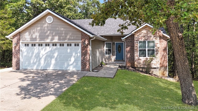 view of front of home featuring a garage and a front yard