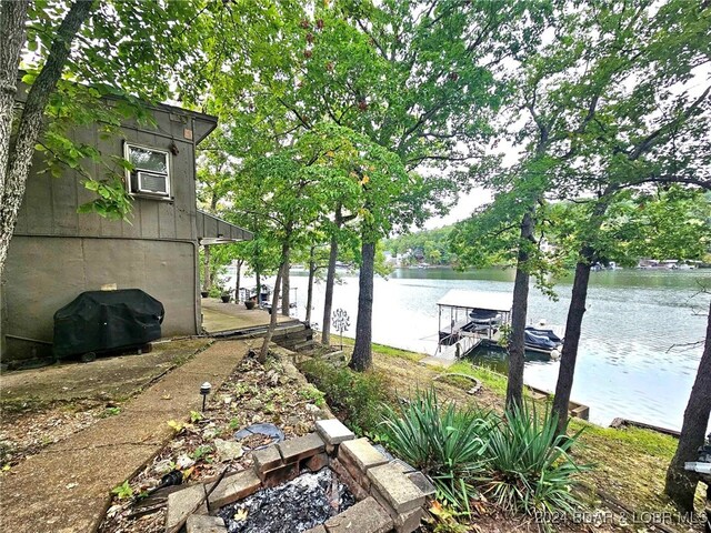 view of yard with a water view and a boat dock