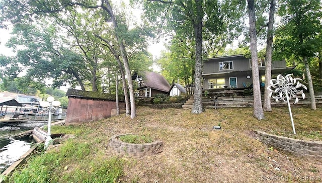 view of yard featuring an outbuilding and a water view