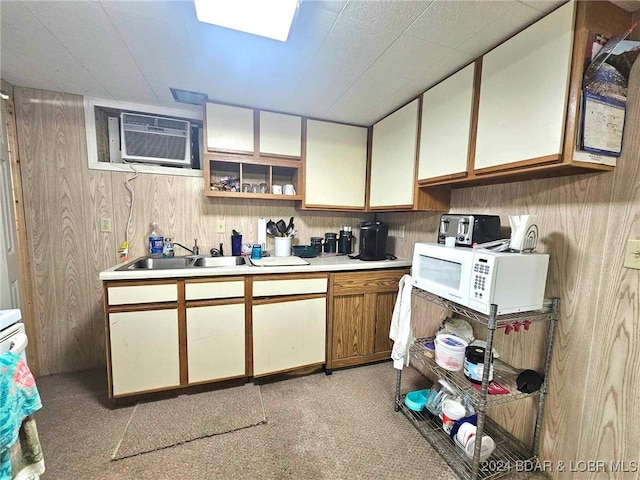 kitchen featuring a wall mounted AC, sink, and wooden walls