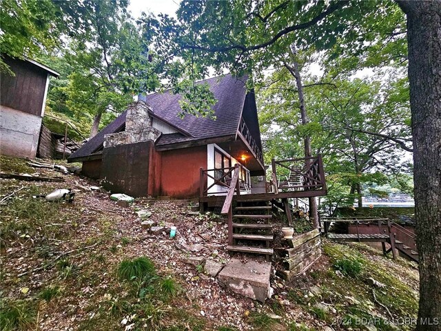 view of side of property featuring a wooden deck