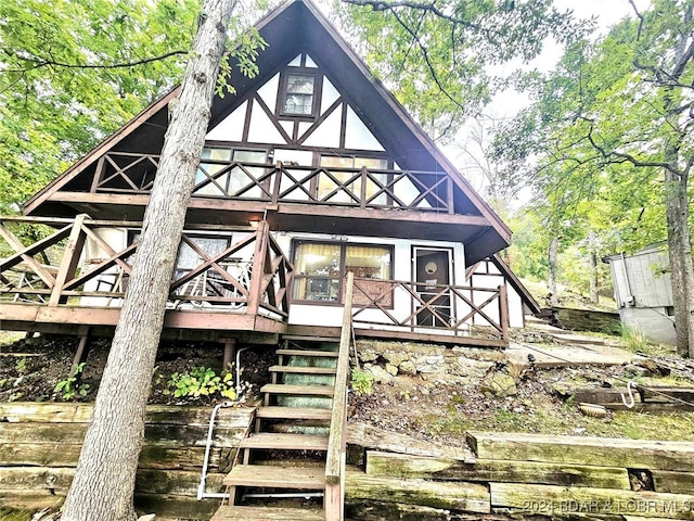 back of house featuring a wooden deck