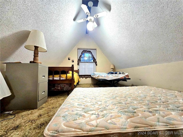 carpeted bedroom with vaulted ceiling and a textured ceiling