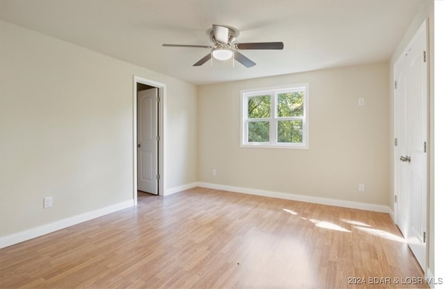 unfurnished room featuring light hardwood / wood-style flooring and ceiling fan