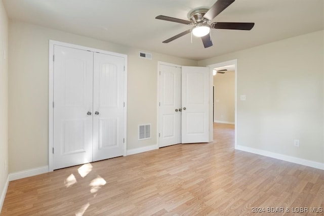 unfurnished bedroom featuring light wood-type flooring and ceiling fan