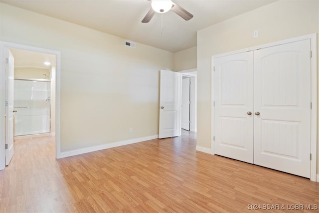 unfurnished bedroom featuring light hardwood / wood-style flooring, ceiling fan, and a closet