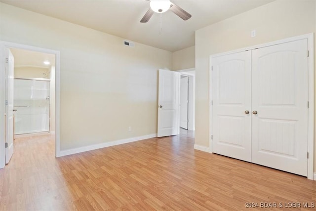 unfurnished bedroom with visible vents, connected bathroom, light wood-type flooring, a closet, and baseboards