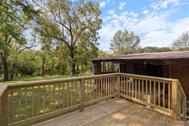 wooden deck with a lawn