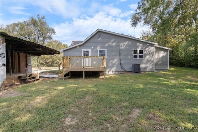 back of house with a lawn, a deck, and central AC unit