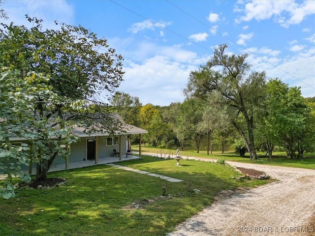 exterior space with a porch and gravel driveway