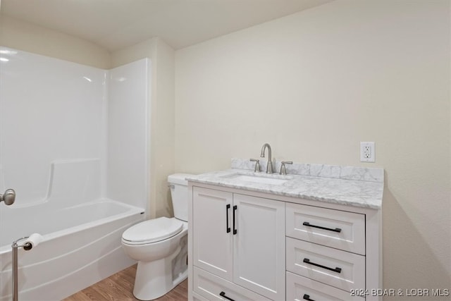 full bathroom with vanity, toilet, wood-type flooring, and bathing tub / shower combination