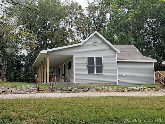 exterior space with a front lawn and a shingled roof