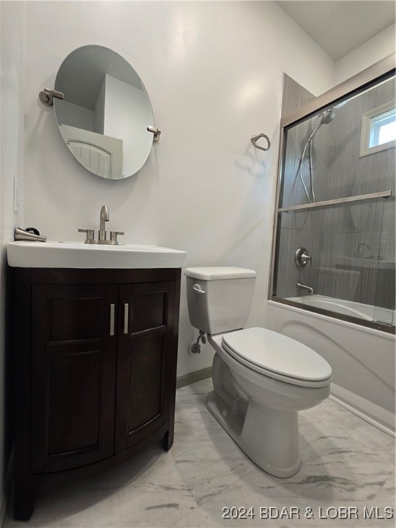 full bathroom featuring shower / bath combination with glass door, vanity, and toilet