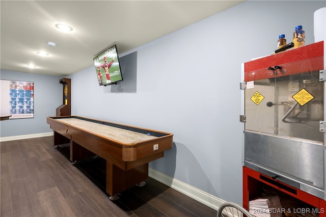 playroom with a textured ceiling and dark hardwood / wood-style floors