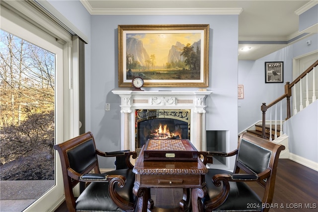 dining space featuring dark wood-type flooring, a fireplace, and ornamental molding