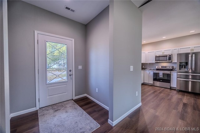 entryway with dark hardwood / wood-style flooring