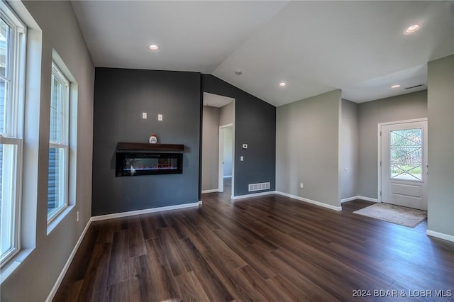 unfurnished living room with dark hardwood / wood-style flooring and vaulted ceiling