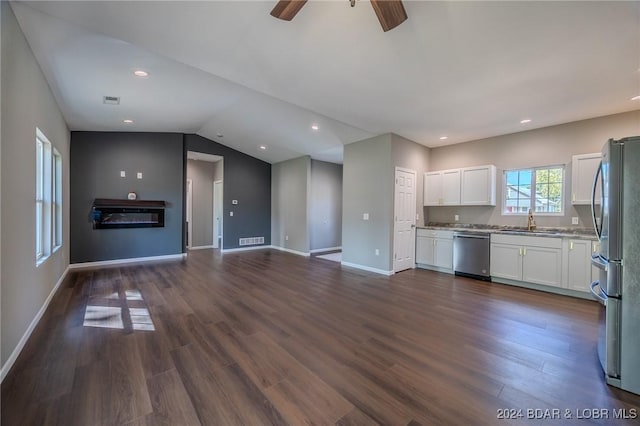 kitchen featuring appliances with stainless steel finishes, ceiling fan, dark wood-type flooring, sink, and white cabinetry