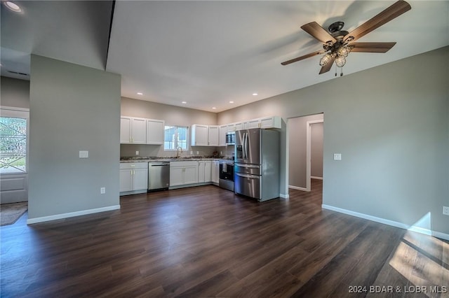 kitchen featuring dark wood-type flooring, white cabinets, sink, ceiling fan, and stainless steel appliances