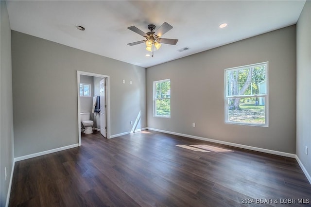 empty room with ceiling fan and dark hardwood / wood-style flooring