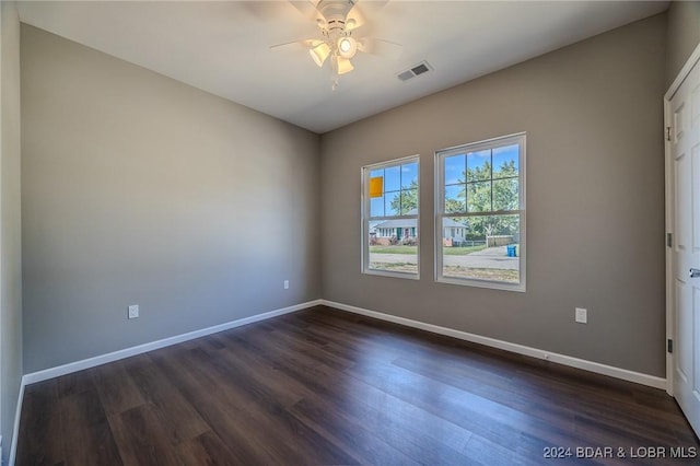 unfurnished room featuring ceiling fan and dark hardwood / wood-style floors