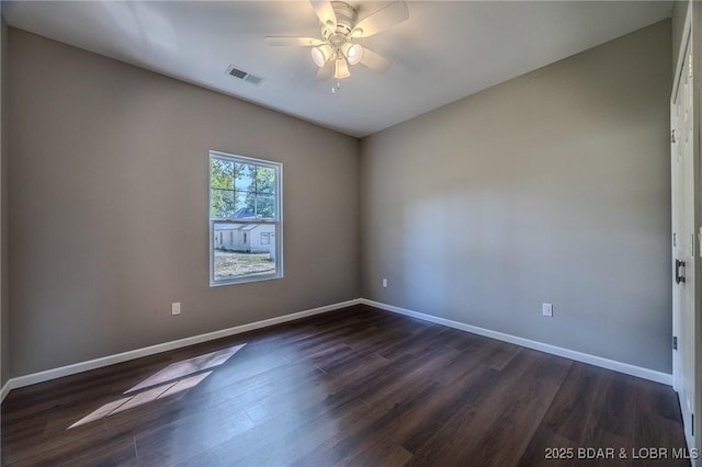 unfurnished room featuring ceiling fan and dark wood-type flooring