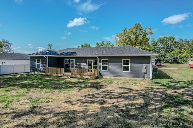 view of front of home with a front yard and a deck