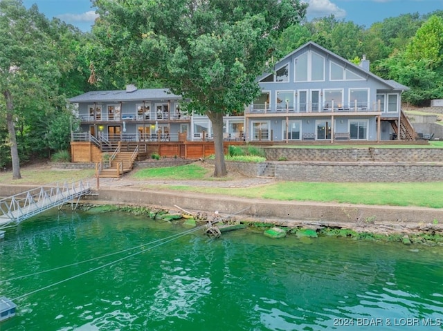 back of house with a deck with water view