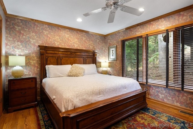 bedroom with ceiling fan, crown molding, and dark hardwood / wood-style flooring