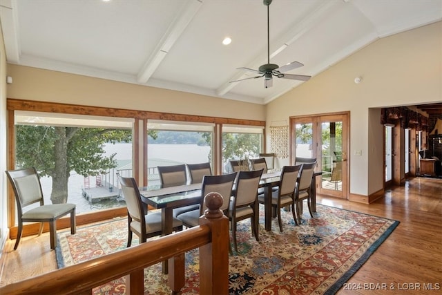 dining room featuring a water view, dark wood-type flooring, beam ceiling, ceiling fan, and french doors