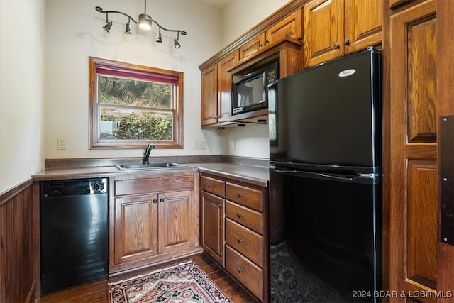 kitchen with black appliances, dark hardwood / wood-style floors, and sink